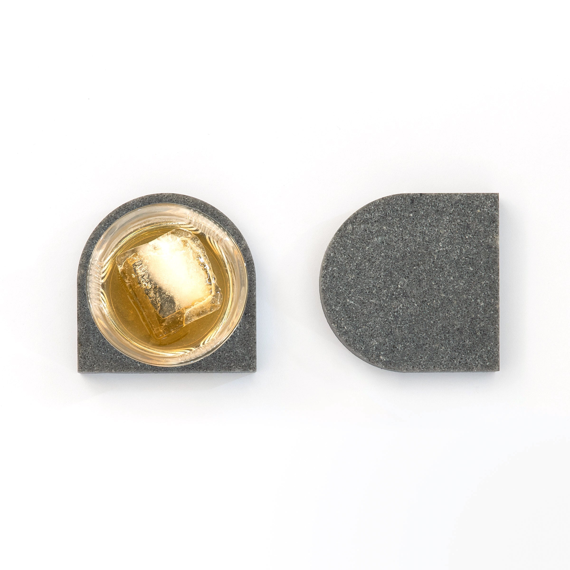 Quartz Arch Coaster™ Set 2 Piece in Rugged Concrete™. Quartz Rugged Concrete™ stone coasters in an arch shape. These dark grey quartz coasters have a cork backing. white and grey marble coasters in appearance however quartz has greater scratch resistance and is lower maintenance. caesarstone quartz