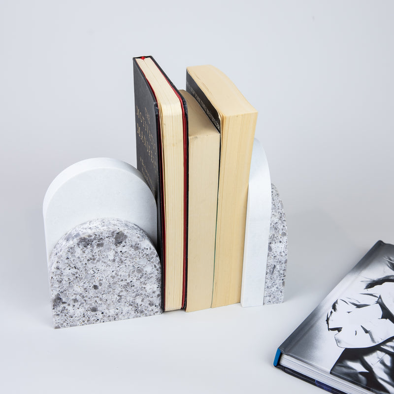 Quartz Bookend Set is 4cm thick. Styled with books. Available in Atlantic Salt partnered with Organic White by Caesarstone with a light grey base peppered with whites, browns, and blacks, in a mix that conjures the purity of unrefined sea salts, meets a clean white surface with subtly blended undertones, reflecting a natural appearance that is effortlessly chic. The perfect addition to your home decor, similar to marble bookends.
