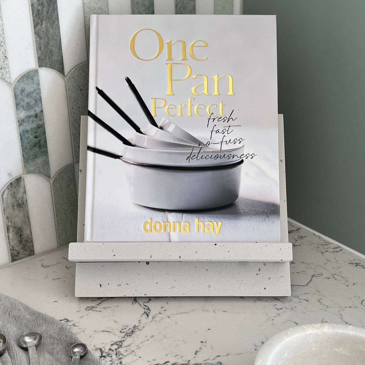 Cookbook Stand in Caesarstone Frozen Terra. Made from quality marble like material. Featuring One Pan Perfect Cookbook by Donna Hay.