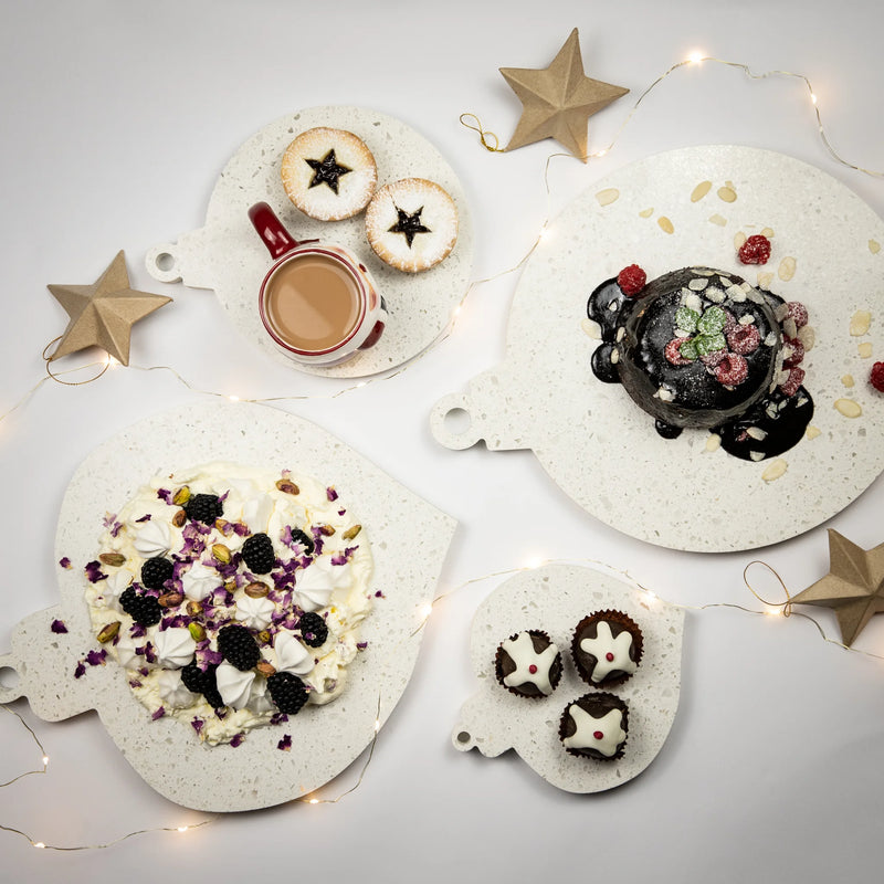 Caesarstone Nougat similar to marble. Serving platters shaped like Christmas decorations. Shown served with Christmas Pudding, fresh raspberries and almond flakes. Christmas Fruit Mince Pies and Pavlova. 