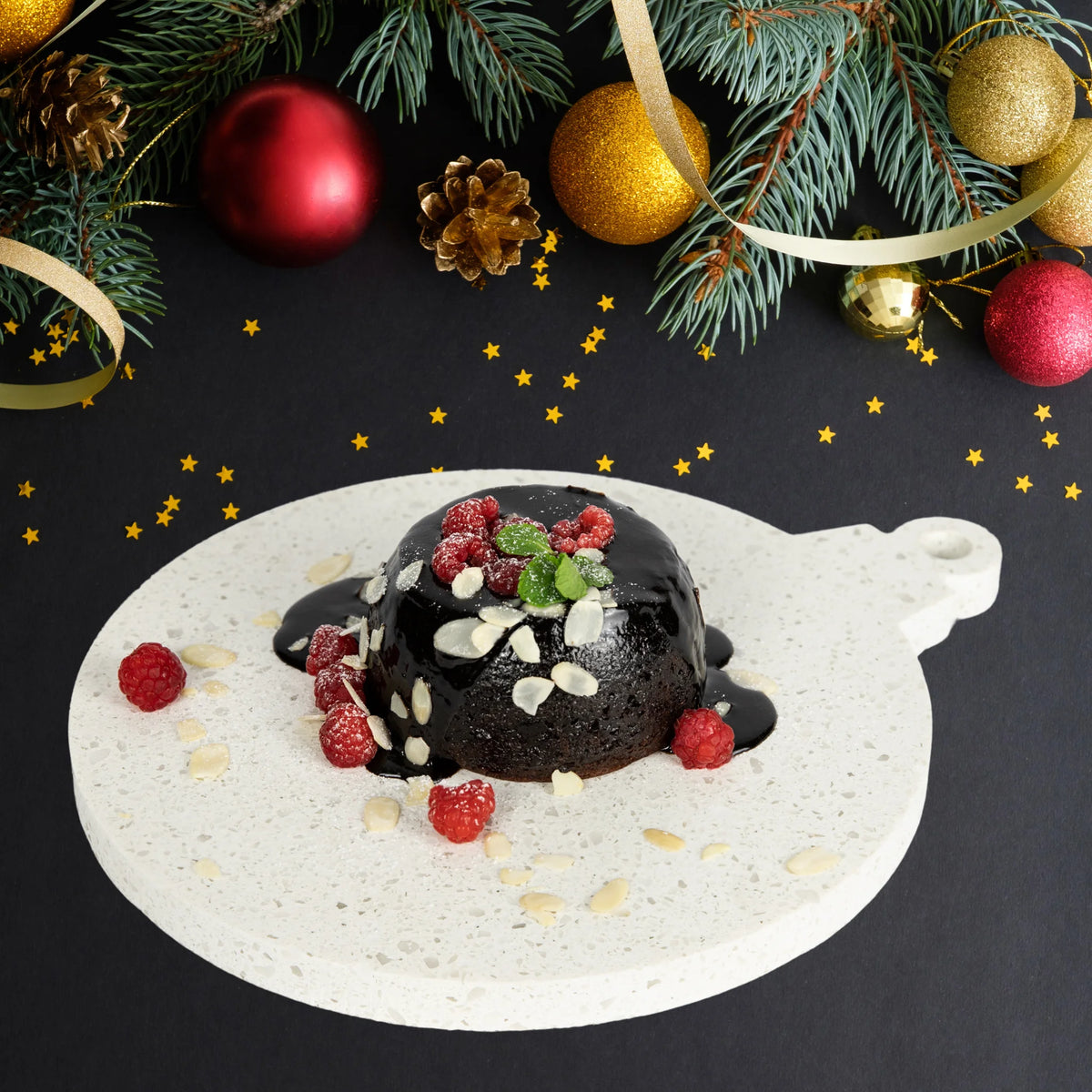 Stone Platter in Caesarstone Nougat, similar to marble. Dessert platter shaped like Christmas bauble. Shown served with Christmas Pudding, fresh raspberries and almond flakes. 