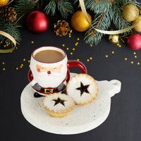 Stone Platter in Caesarstone Nougat, similar to marble. Decorative tray shaped like Christmas bauble. Shown served with Christmas fruit mince pies and santa mug.