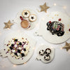 Stone Platters in Caesarstone Nougat, similar to marble. Serving platters shaped like Christmas decorations. Shown served with Christmas Pudding, fresh raspberries and almond flakes. Christmas Fruit Mince Pies and Pavlova. 