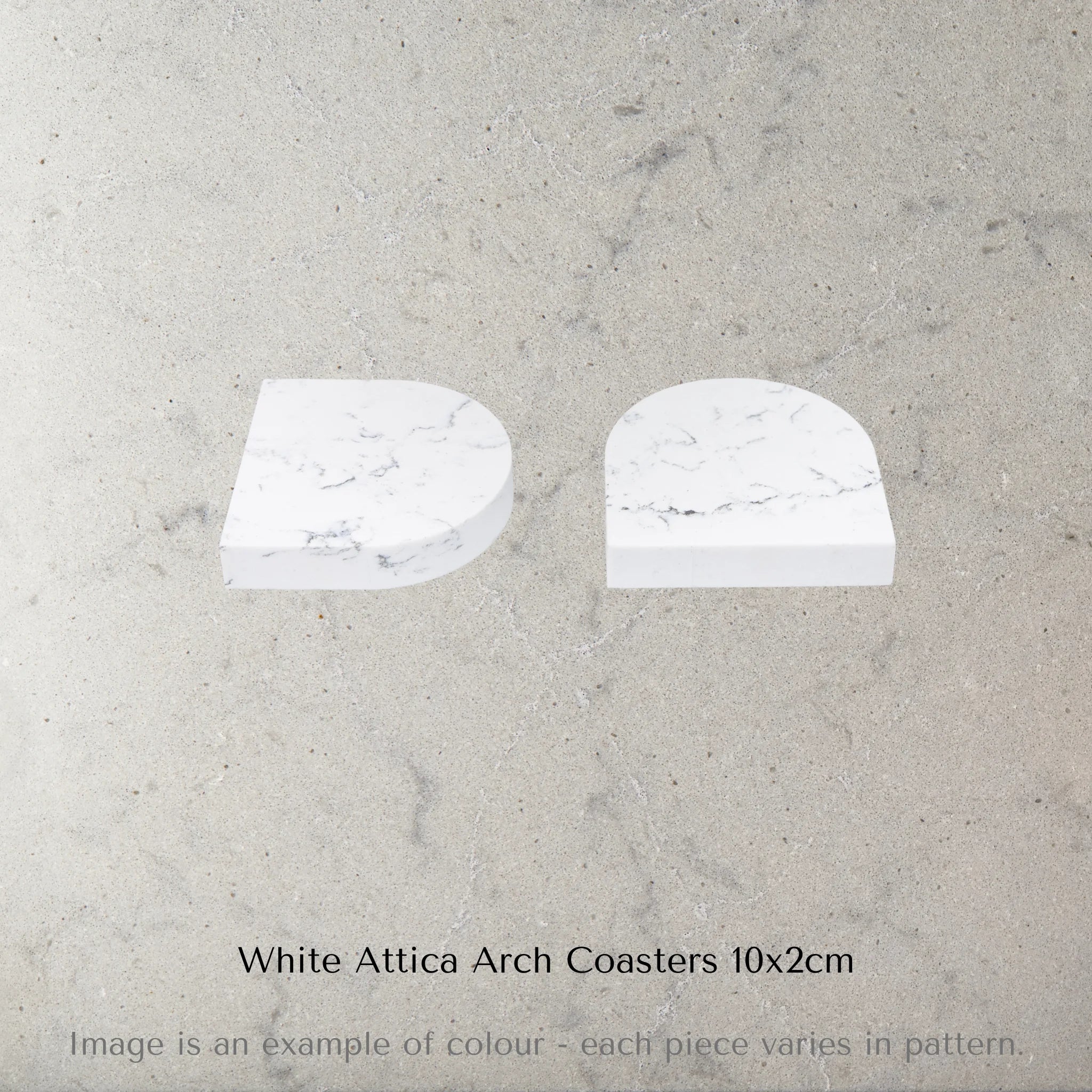 Two Caesarstone White Attica Arch Coasters on a grey marble surface with text 'White Attica Arch Coasters 10x2cm'.