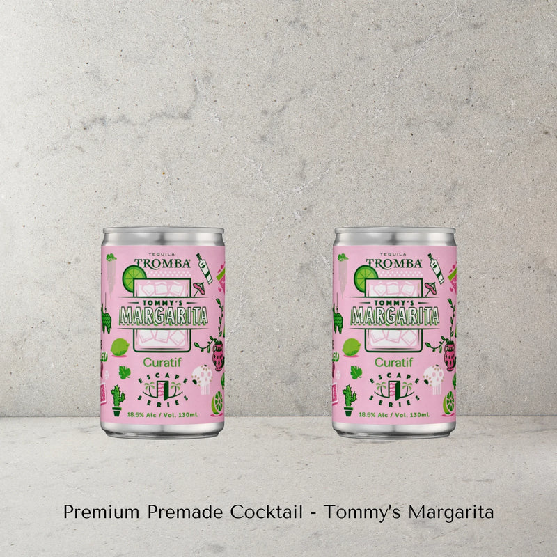 Two cans of Tommy's Margarita cocktail made by Curatif with Tromba Tequila on a concrete surface with a grey background with text 'Premium Premade Cocktail - Tommy's Margarita'.