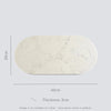 Marble-patterned oval stone food platter with dimensions on a light gray background.
Caesarstone Georgian Bluffs created by Aureliia Collection. 