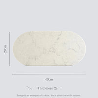 Marble-patterned oval stone food platter with dimensions on a light gray background.
Caesarstone Georgian Bluffs created by Aureliia Collection. 