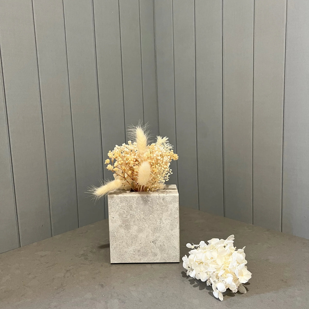 Solid stone mini vase in Caesarstone Primordia with mini dried flower posy. This is the gift to buy when you think what to buy for someone that has everything.