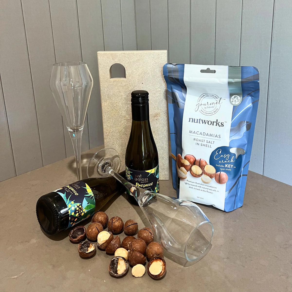 Gift Pack - Perfect Pair. Include mini cheese board, Just a Glass King Valley Prosecco bottles, DStill unbreakable  prosecco flutes. Gourmet by Nutworks Roast Salt - Macadamia in Shell.